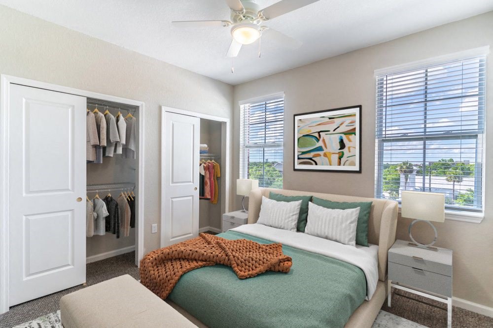 a bedroom with a bed and a ceiling fan