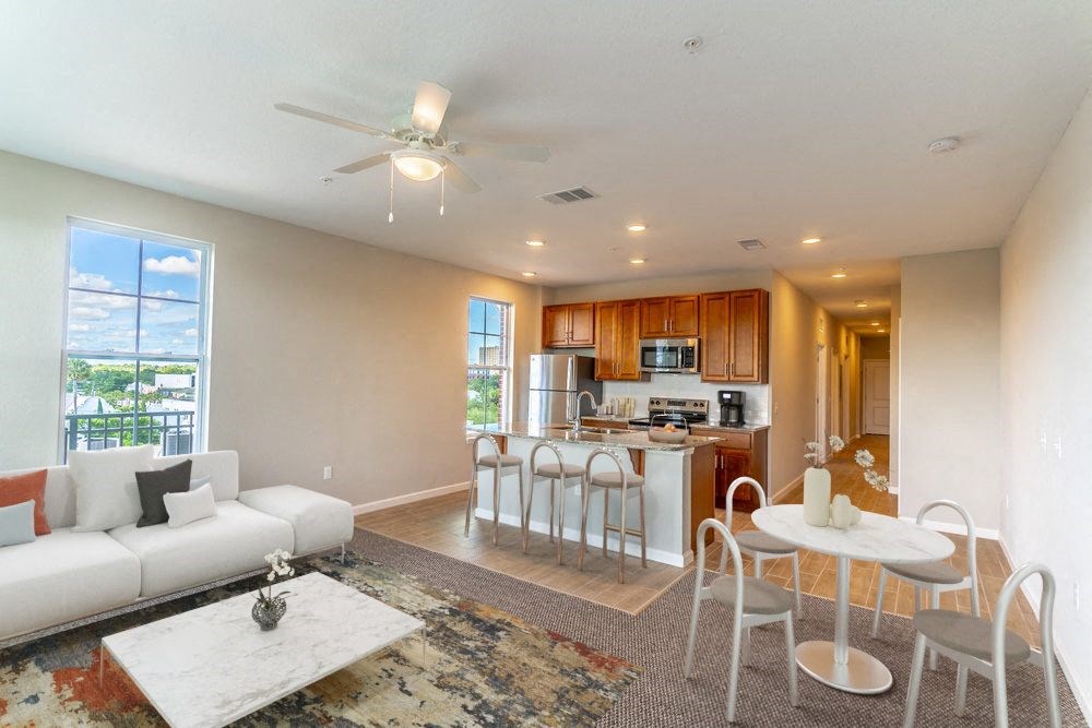 a living room and kitchen with a couch and a table