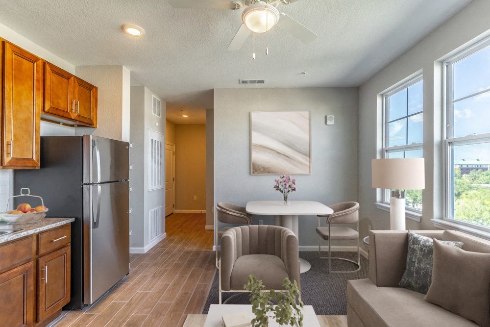 a living room with a kitchen and a table and chairs