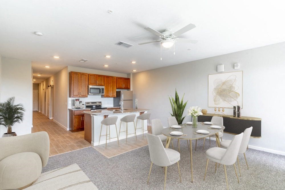a living room and kitchen with a table and chairs