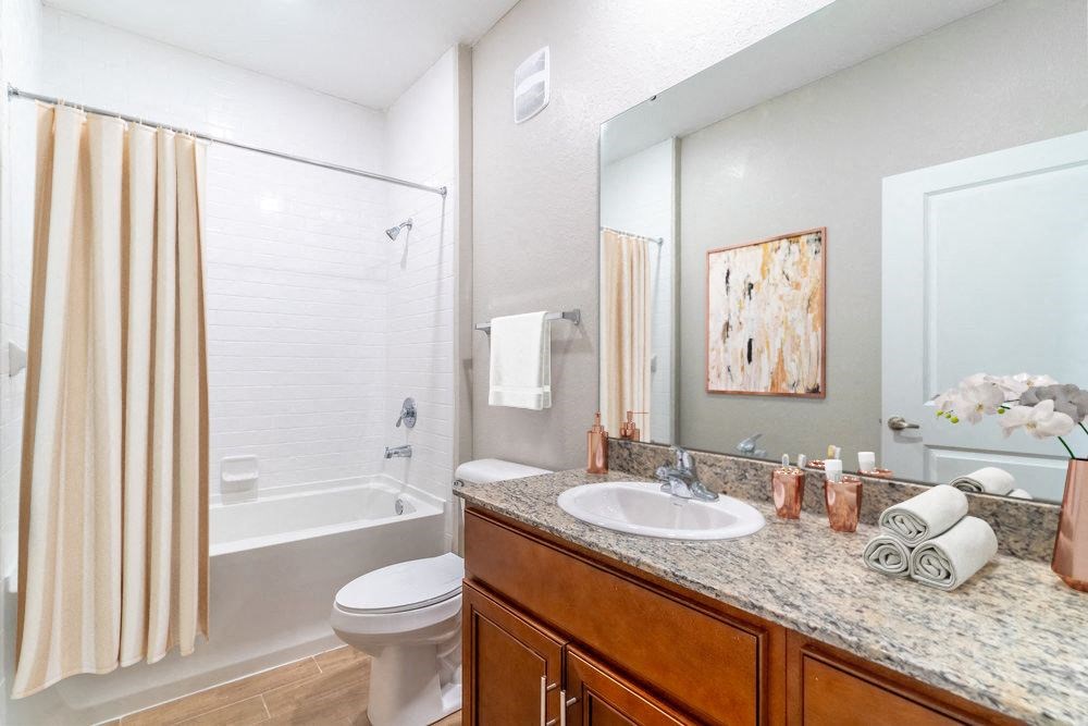 a bathroom with a sink and a shower and a toilet