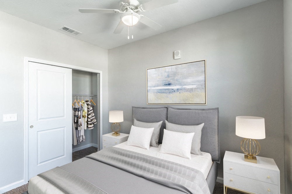 a bedroom with a bed and a ceiling fan