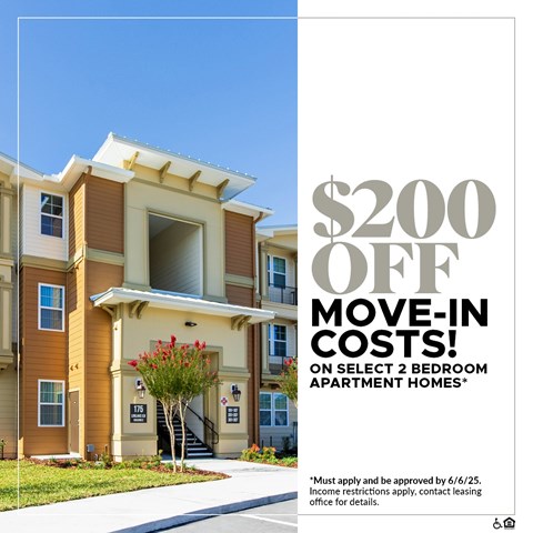Apartment complex with a sign offering $200 off move-in costs.