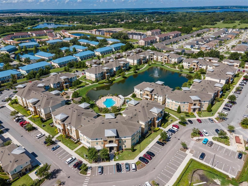 an aerial view of a community with a large lake in the middle of it