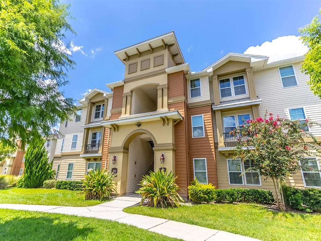 a large apartment building with a walkway in front of it