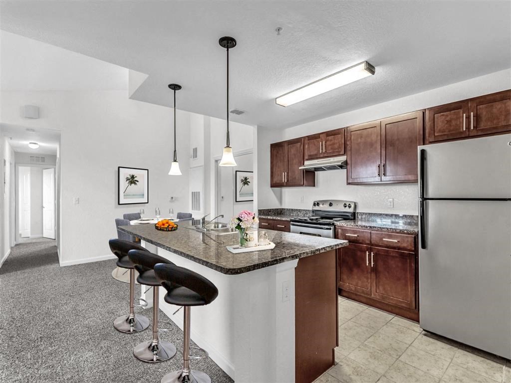 a kitchen with a counter top next to a stove top oven