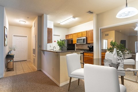 a kitchen and dining room with a table and chairs