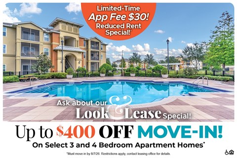 A large apartment complex with a pool and a sign offering a limited-time app fee discount.