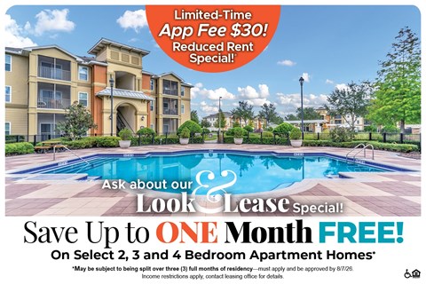 A large apartment complex with a pool and a sign offering a free month if you sign up for a lease.
