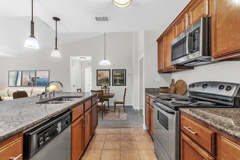 a kitchen with stainless steel appliances and granite counter tops