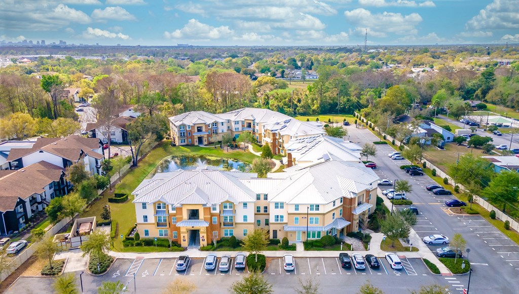 an aerial view of a large building with a fountain in the middle of a parking lot