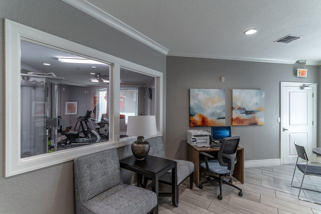 a room with a desk and chair and a mirror