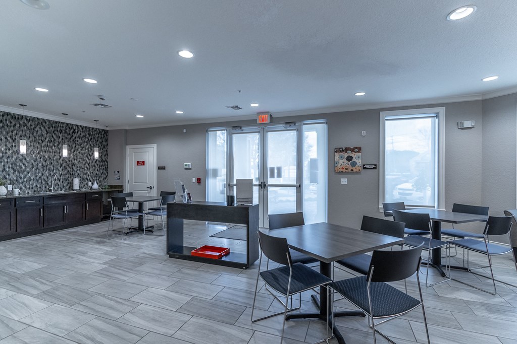 a dining area with a table and chairs