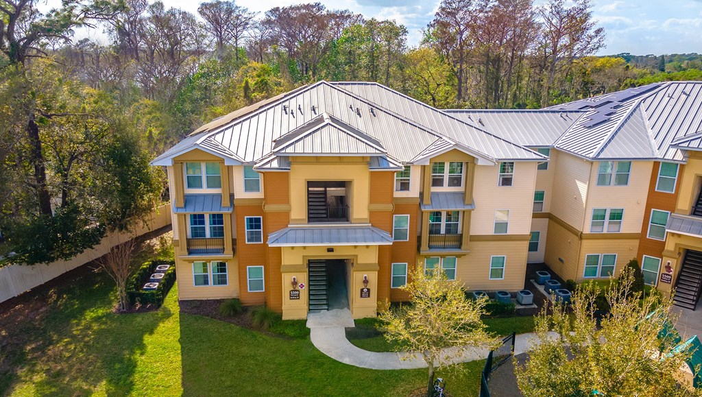 an aerial view of a large apartment building with a metal roof