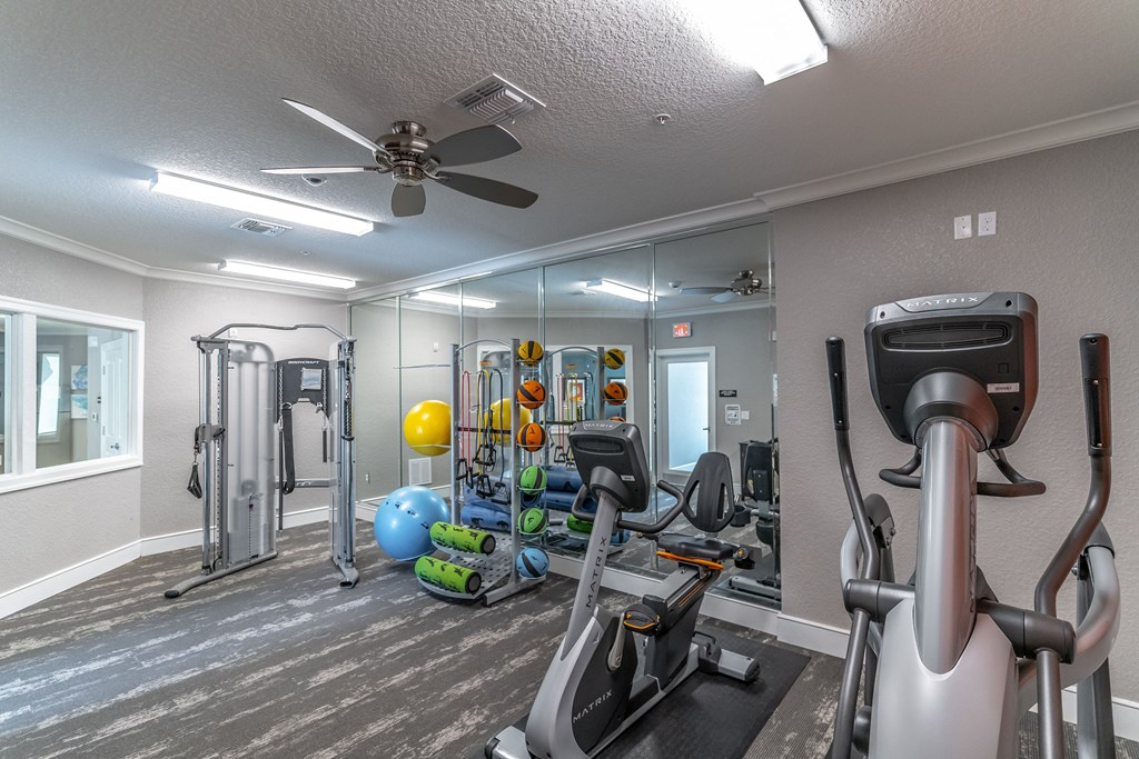 fitness center with equipment and mirror