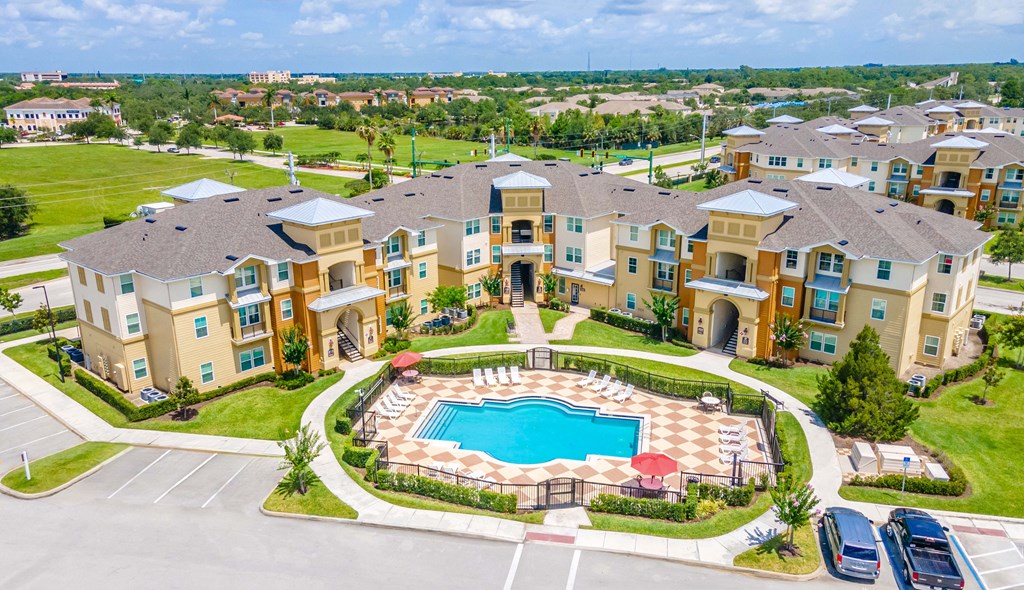 an aerial view of an apartment complex with a swimming pool
