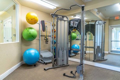 fitness center with equipment and mirror