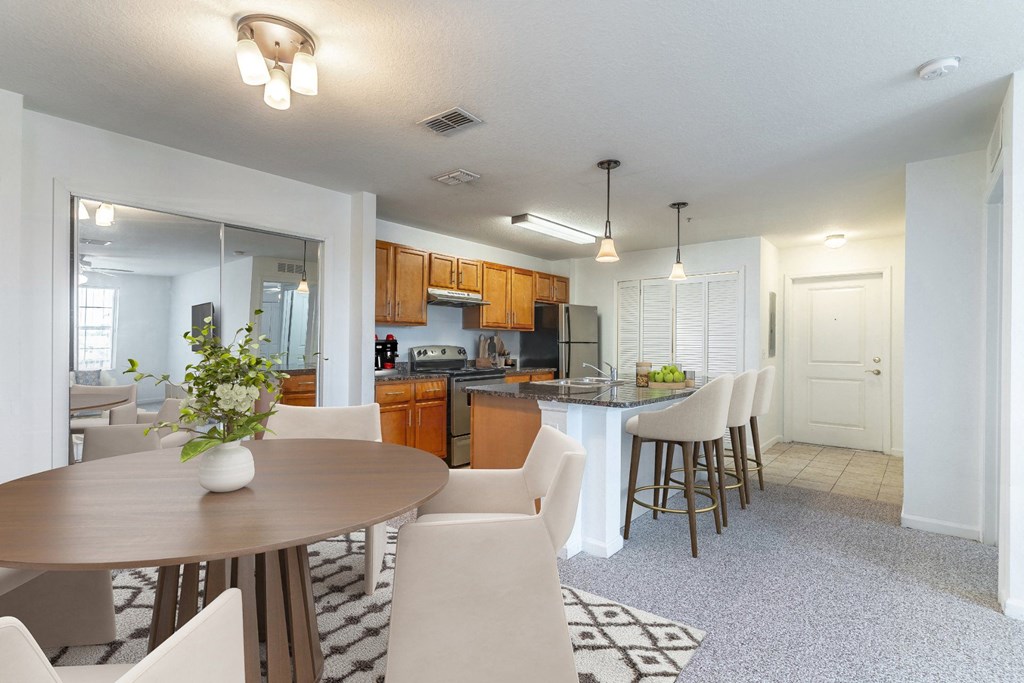 a kitchen and dining area with a table and chairs