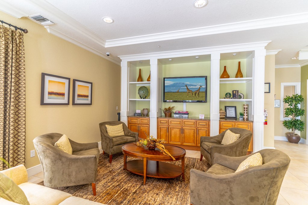 a clubhouse filled with furniture and a flat screen tv