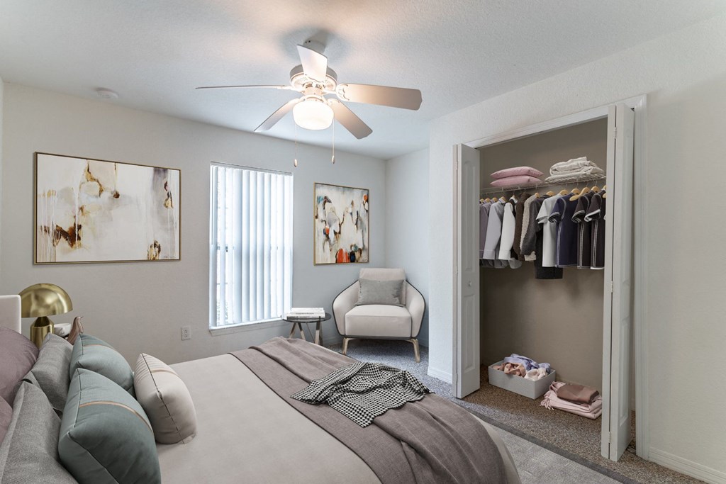 a bedroom with a ceiling fan and closet