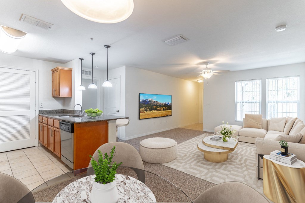 a living room with a kitchen and dining area