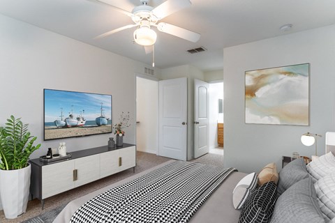 a bedroom with a large bed and a ceiling fan