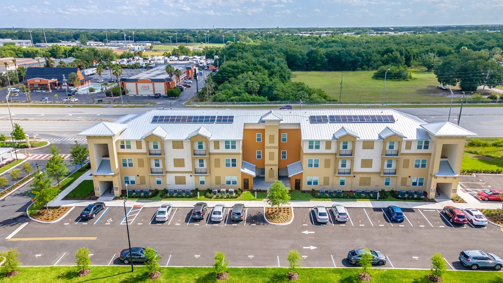 a large apartment building with solar panels on the roof