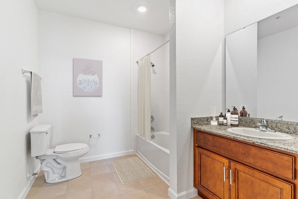 a bathroom with a toilet sink and shower