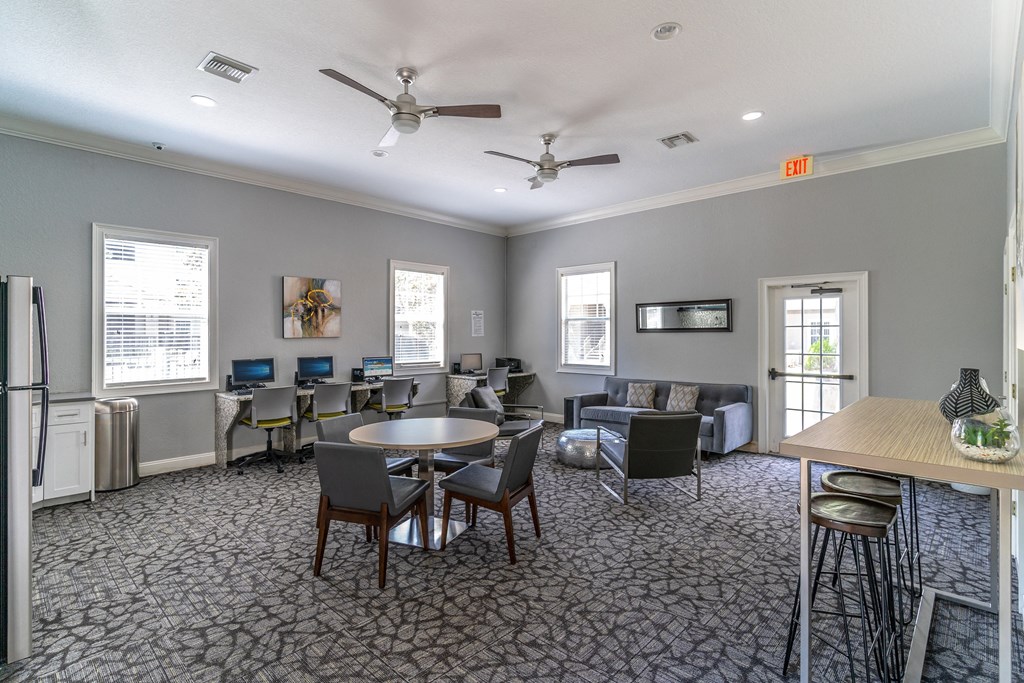 a room with couches and chairs and a table and chairs