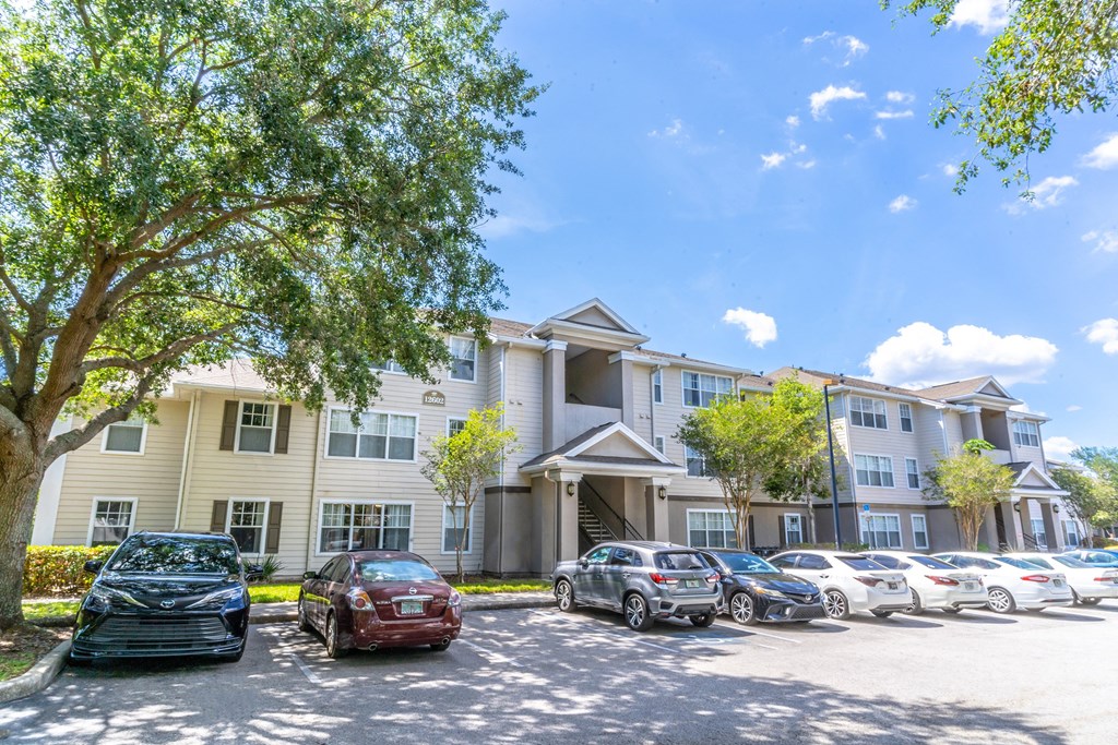 a large apartment building with a parking lot in front of it
