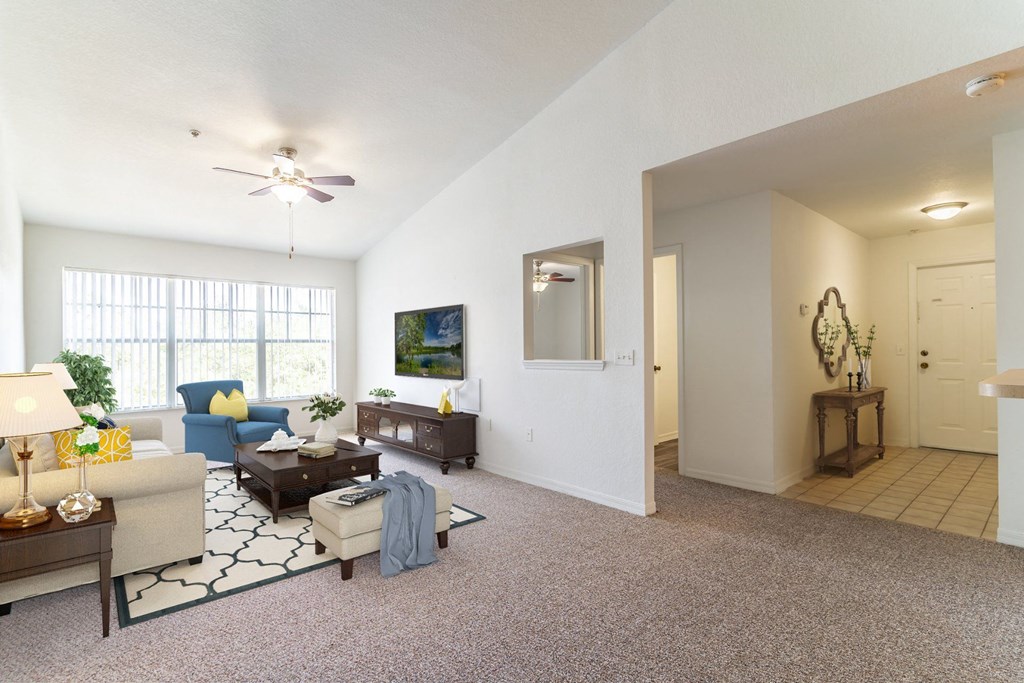 a living room with white walls and carpet
