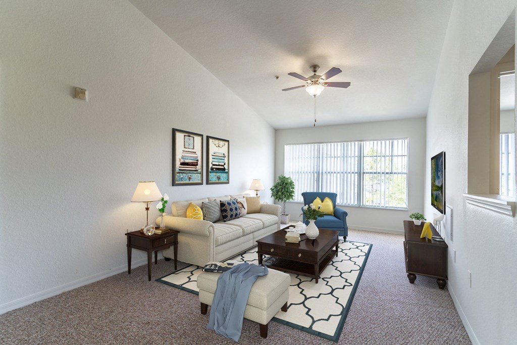 a living room with a ceiling fan and a large window
