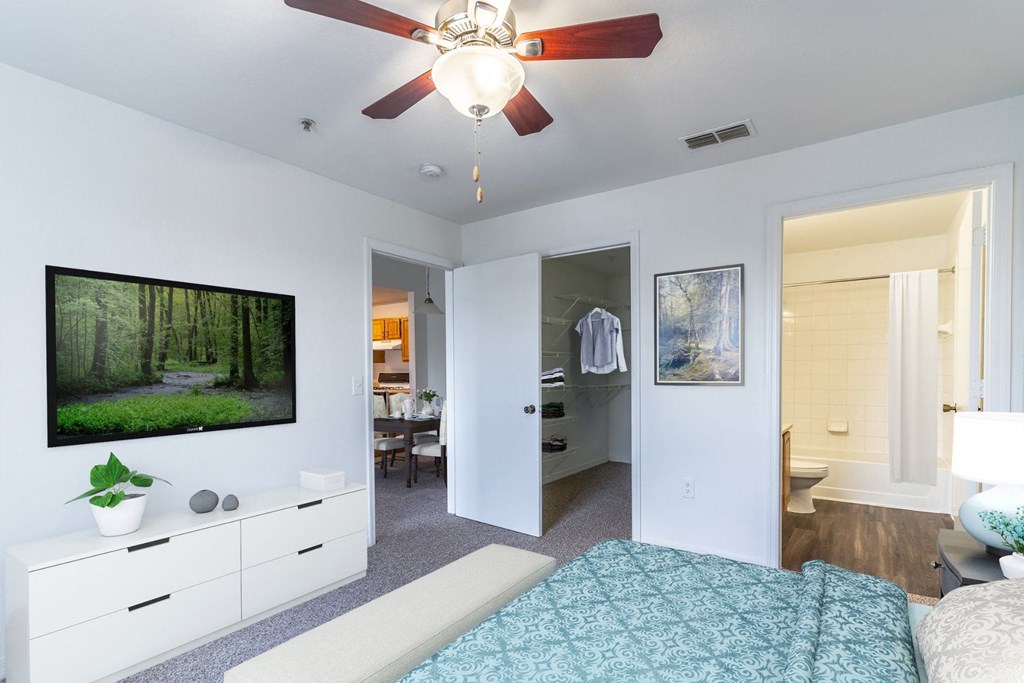 a bedroom with a bed and a ceiling fan