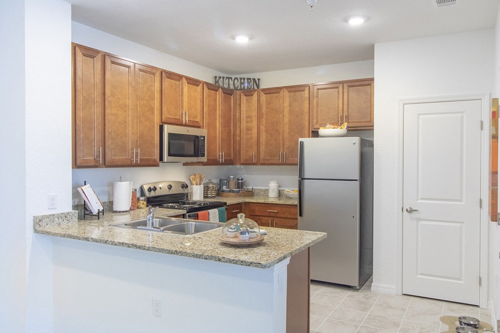 a kitchen with a granite counter top and stainless steel appliances