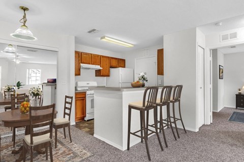 the view of a kitchen and dining area with a table and chairs