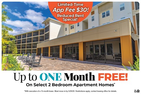 A building with a sign offering a free month's rent on select 2 bedroom apartment homes.