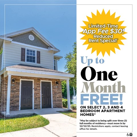 A small house with a sign offering a free month on select bedroom apartments.