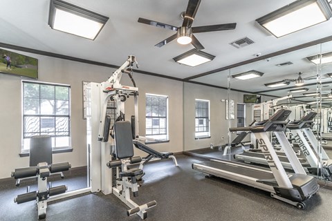 a gym with exercise equipment and windows