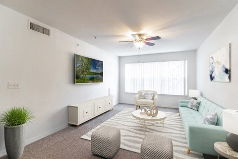 a living room with white walls and a large window