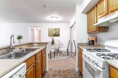 a kitchen with white appliances and wooden cabinets