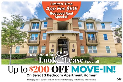 A large apartment complex advertises a limited-time app fee reduction and a move-in special.