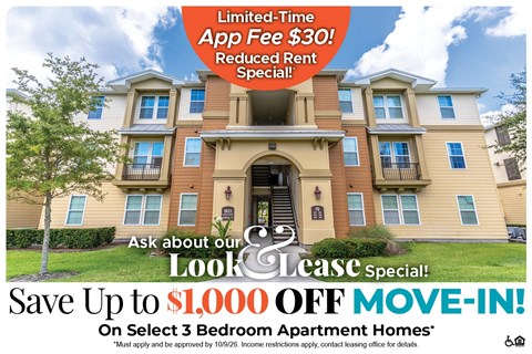 A large apartment complex advertises a limited-time app fee reduction and a move-in special.