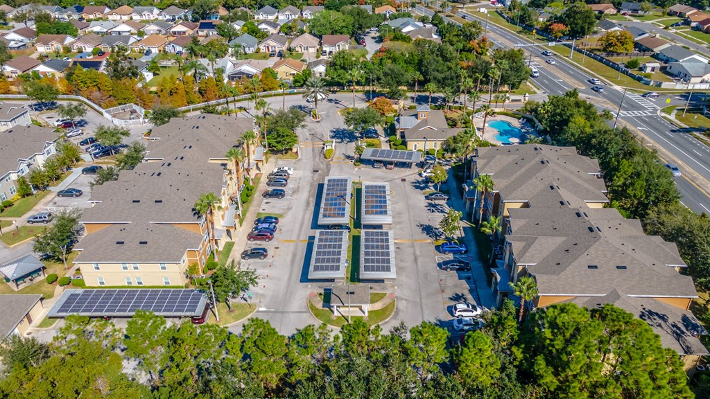 an aerial view of a neighborhood with solar panels on the roofs
