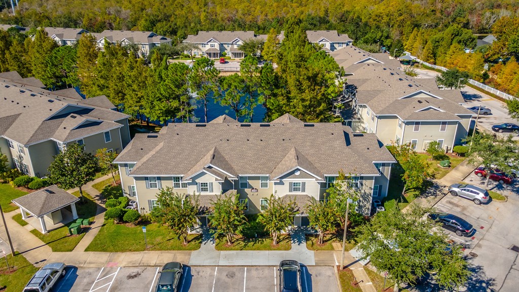 A bird's eye view of a residential area with houses and cars.