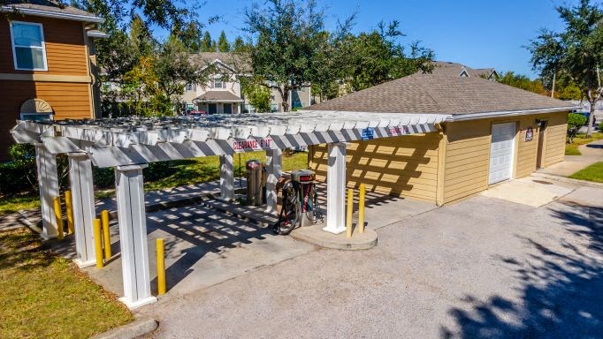 a bike parked under awning in front of a house