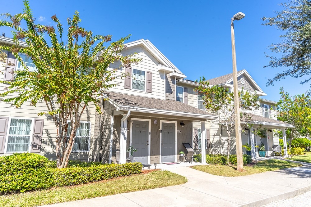A house with a tree in front of it.