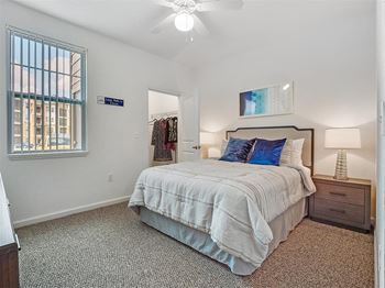 a bedroom with a bed and a ceiling fan
