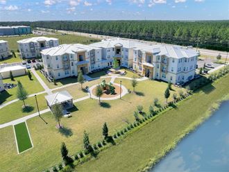 a building with a large yard next to a body of water
