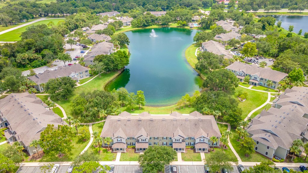 an aerial view of a neighborhood with a lake and houses