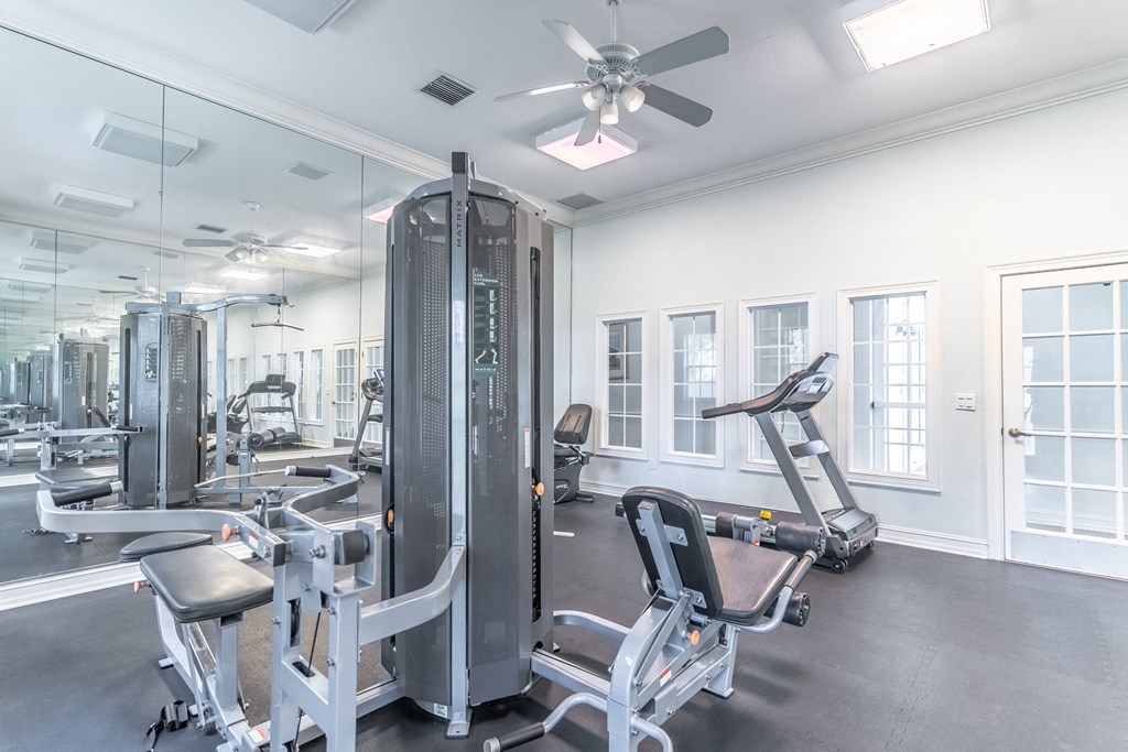 fitness center with equipment and mirror